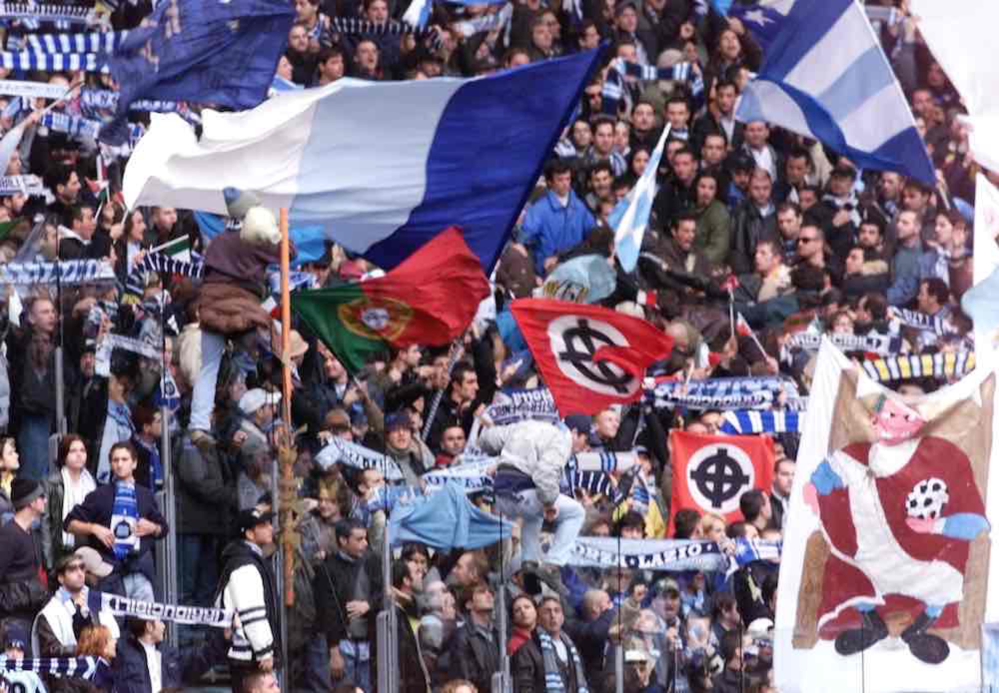 S.S. Lazio fans, known as the <em>Irriducibili</em>, fly neo-Nazi flags during the derby against A. C. Roma at the Olympic Stadium, 21 November 1999. The <em>Irriducibili</em> were dissolved in 2020.