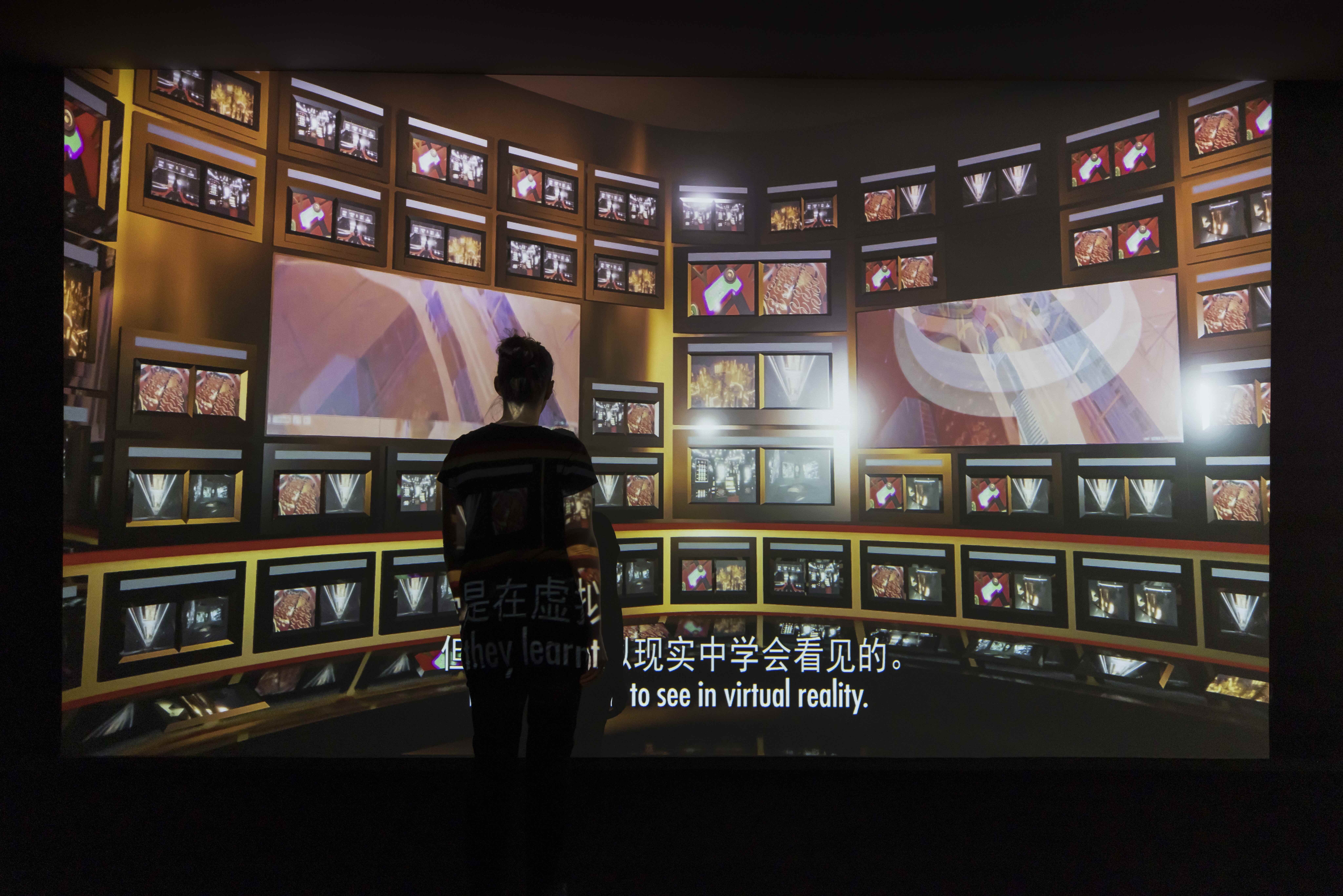 Korakrit Arunanondchai and Alex Gvojic (with Tosh Basco), No history in a room filled with people with funny names 5 (detail), 2018, installation view, Ultra Unreal, Museum of Contemporary Art Australia, Sydney, 2022, 3-channel video, HD, colour, sound, resin casts of Basco’s head and Arunanondchai’s grandfather’s hands, seashells, plants, soil, mirror, laser, LED, haze, image courtesy and © the artist, photograph: Alex Davies