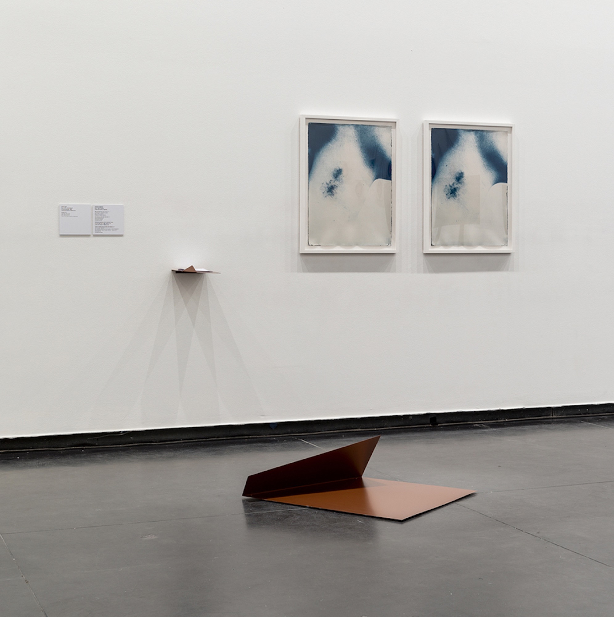 Spence Messih, <em>River beneath the river (I & II)</em> (installation view), 2017, cyanotype on watercolour paper, © the artist, courtesy of Artbank Sydney; <em>You move (on the other side of</em>) (installation view), steel testosterone gel (with text by Vincent Silk). Image credit: Andrew Curtis, © the artist
