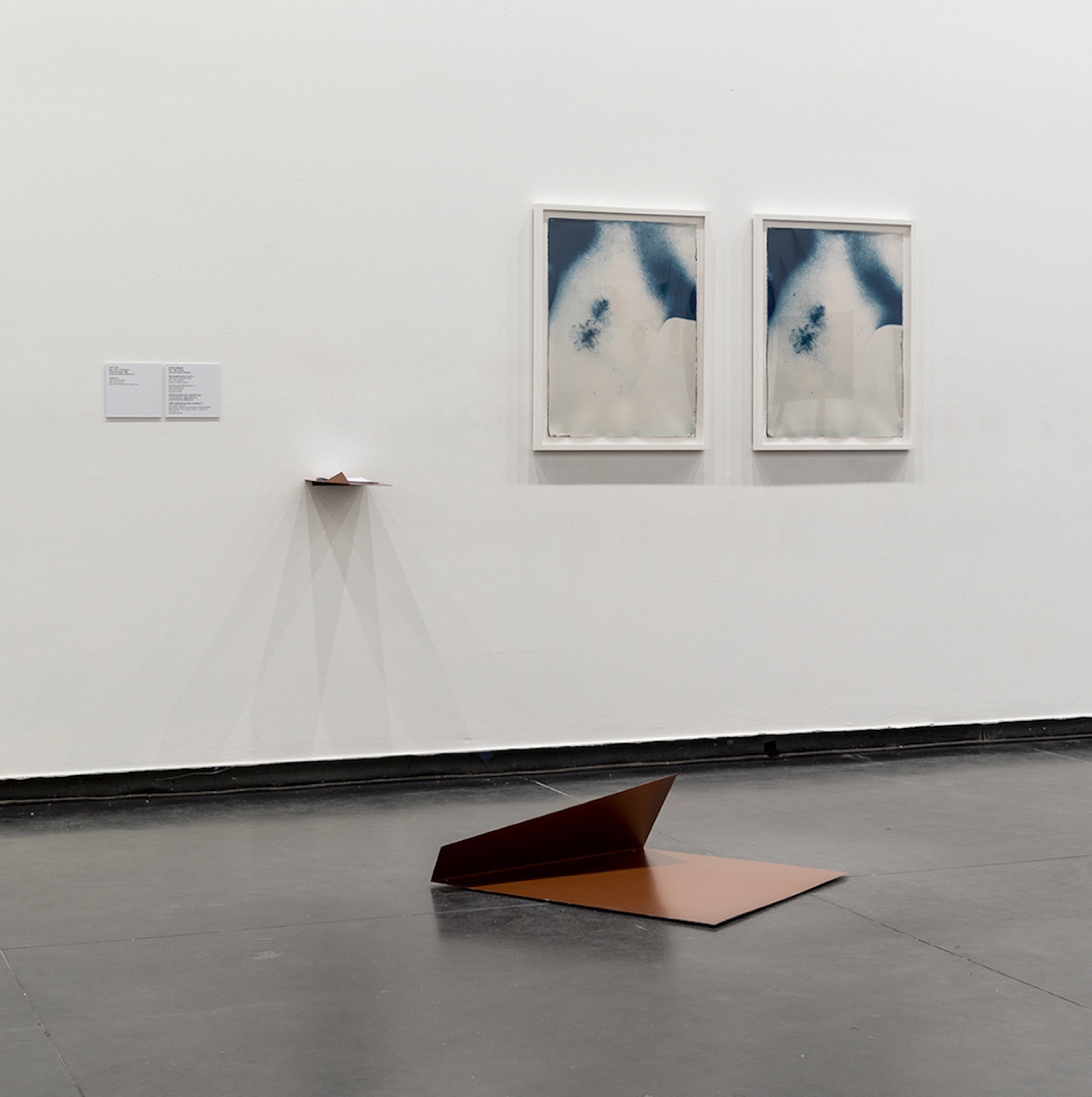Spence Messih, <em>River beneath the river (I &amp; II)</em> (installation view), 2017, cyanotype on watercolour paper, © the artist, courtesy of Artbank Sydney; <em>You move (on the other side of</em>) (installation view), steel testosterone gel (with text by Vincent Silk). Image credit: Andrew Curtis, © the artist