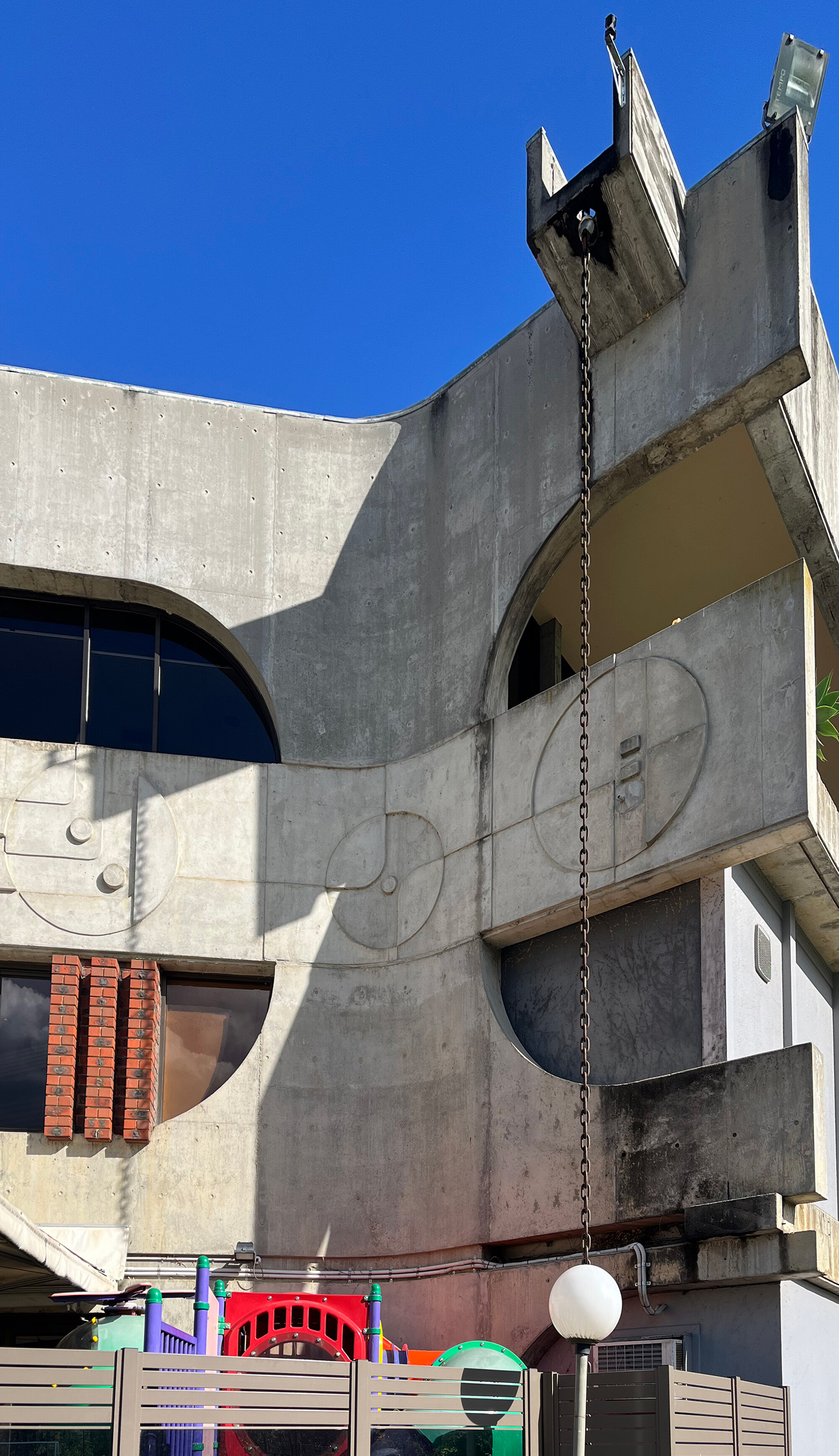 <p>An outdoor terrace with a colourful children’s playground contrasts with the concrete and trough-like gutter of Smrekar’s 1972–1973 design. Photograph by the author.</p>