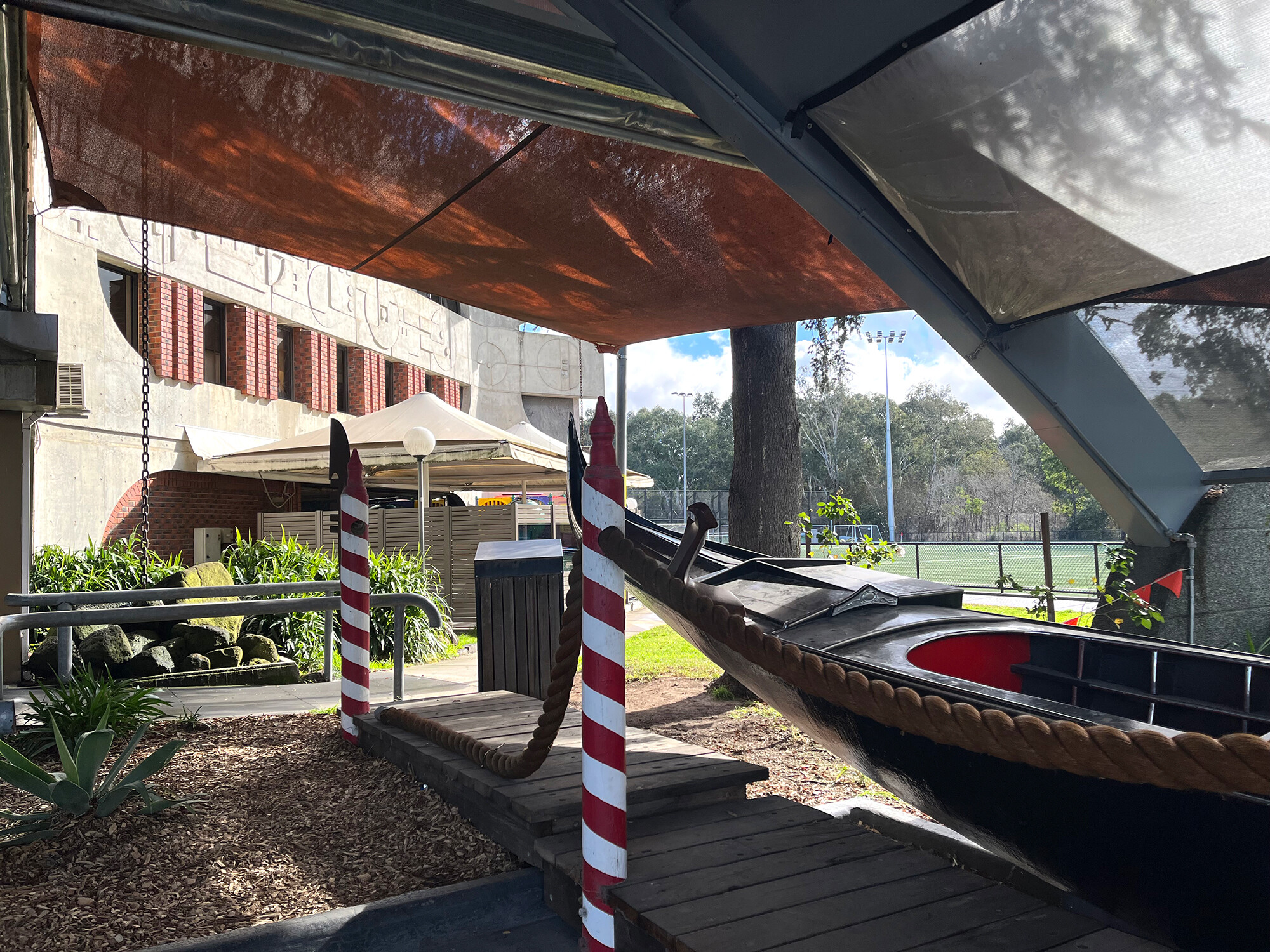 <p>A Venetian gondola near the synthetic soccer pitch. Shading devices and the curved ceiling of the front entrance are later additions, while the brickwork and iconic patterned concrete facing north-east are part of Smrekar’s 1972–1973 design. Photograph by the author.</p>