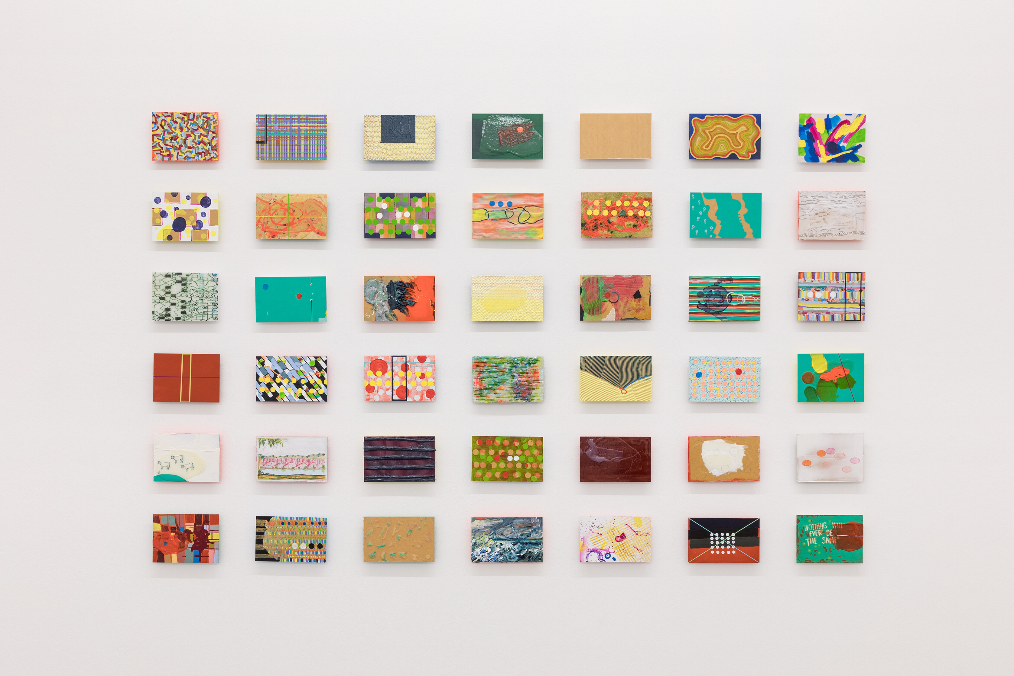 <p>Vivienne Binns, <em>Particle Thought</em>, 2009, acrylic, sand, enamel, oil pastel, colour pencil, glue, felt tip marker, paper on canvas board, forty-two panels, 140 x 220cm. Courtesy the artist and Sutton Gallery, Melbourne. Photo: Andrew Curtis.</p>