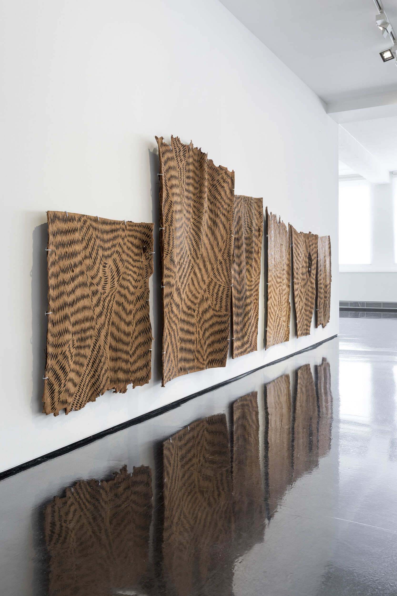 <p>Installation shot,<em>&nbsp;</em>Wanapati&nbsp;Yunupiŋu,&nbsp;<em>Gurtha</em>&nbsp;(2025), etched stringybark, courtesy Tolarno Galleries.</p>