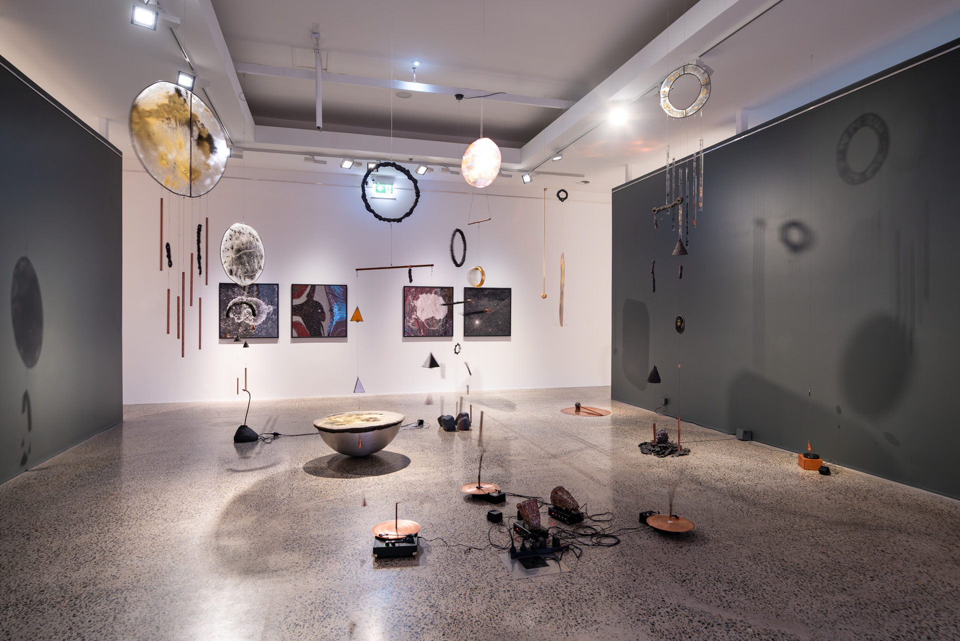 Installation view of <em>West of Central</em>, Bathurst Regional Art Gallery, 1 July–27 August 2023, featuring Vicky Browne, <em>Cosmic Noise</em>, 2018–ongoing, mixed media installation, dimensions variable. Courtesy the artist., Haines & Hinterding, <em>Lichen and Stars 2 (Faulconbridge /NGC4755 Jewel Box Star Cluster),</em> 2021, pigment print on Ilford Gold Fibre Pearl 290gsm, 2 units each 93 x 93 cm (framed), and Haines & Hinterding, <em>Lichen and Stars 4 (Kings Tableland / M8 Lagoon Nebula)</em>, 2021, pigment print on Ilford Gold Fibre Pearl 290gsm, 2 units each 93 x 93 cm (framed). Photo: David Roma Photography