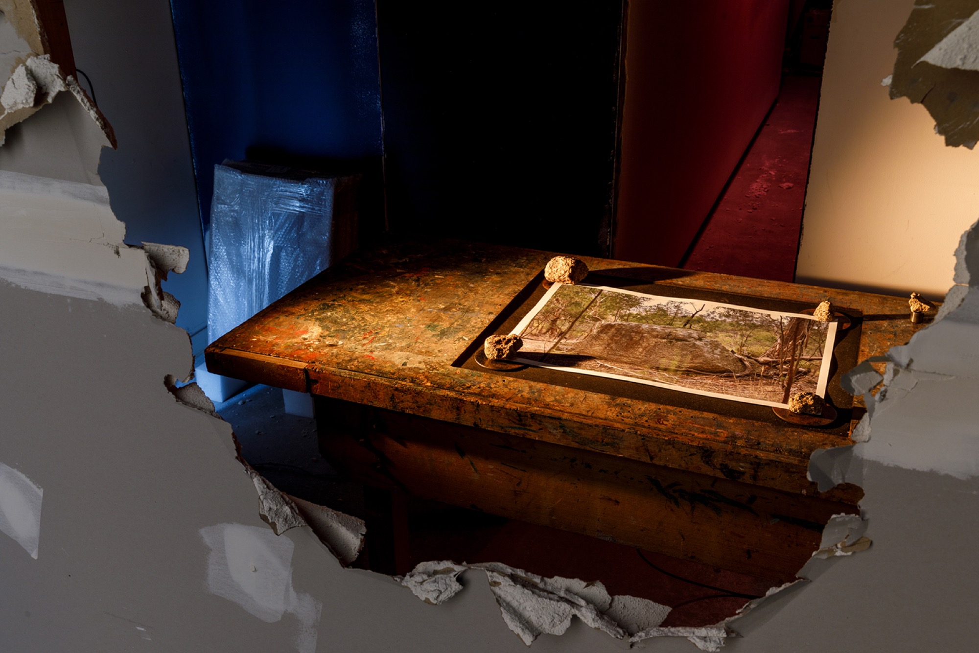 Steven Rhall (Taungurung), <em>Of the Earth</em> 2021, inkjet print, steel, audio, amplifier, subwoofer, granite, table, light, architectural intervention, framed and wrapped inkjet prints, dimensions variable,installation view, WILAM BIIK, TarraWarra Museum of Art, 2021. Courtesy of the artist. Photo: Andrew Curtis.